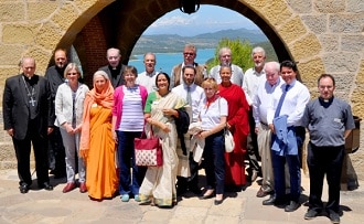 Participants at Torreciudad conference with lake behind