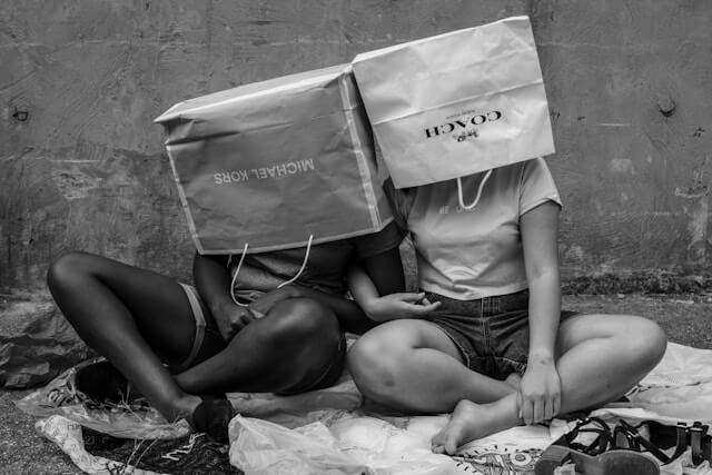 Consumerism Two children with shopping bags over their heads