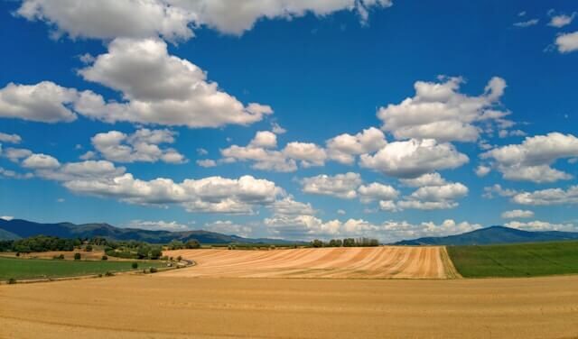 Natural environment Scattered clouds over agricultural land