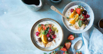 Two bowls of oatmeal with fruit